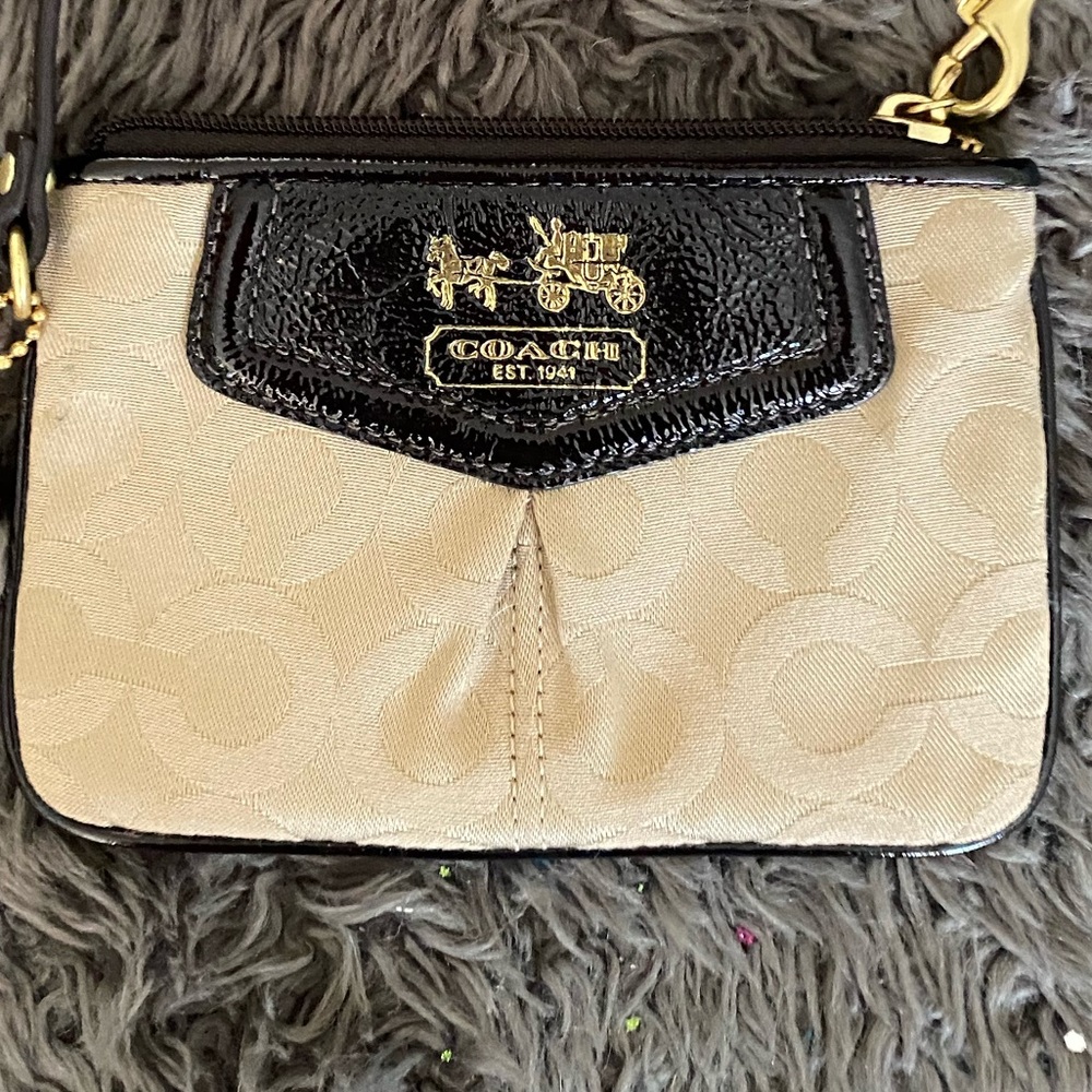 NWOT Coach wristlet with modern “C” on the traditional canvas gold material.